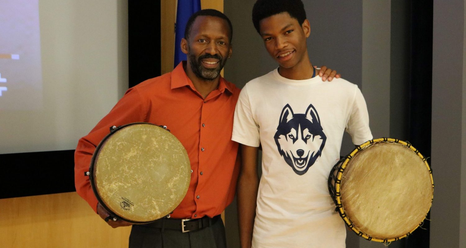 student and counselor with drums